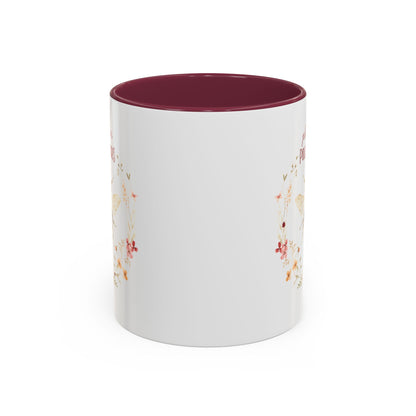 White ceramic mug with a burgundy interior and handle, featuring a watercolor bee and floral wreath.