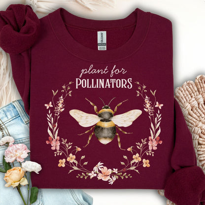 Maroon "Plant for Pollinators" sweatshirt with a watercolor bee and wildflower wreath design.