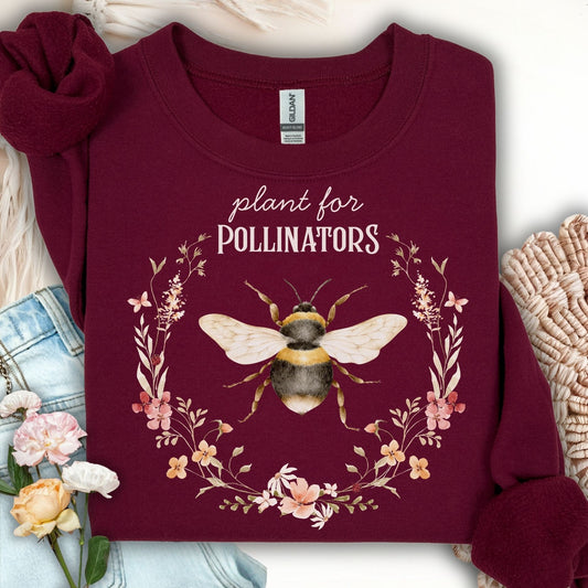 Maroon "Plant for Pollinators" sweatshirt with a watercolor bee and wildflower wreath design.