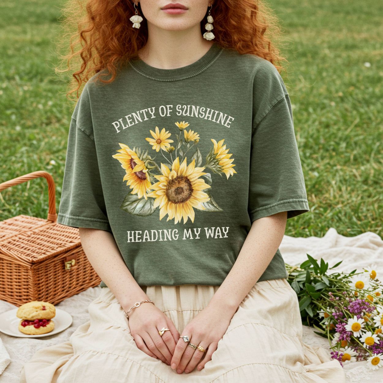 Relaxed-fit, garment-dyed olive green t-shirt with "Plenty of sunshine heading my way" and sunflowers.