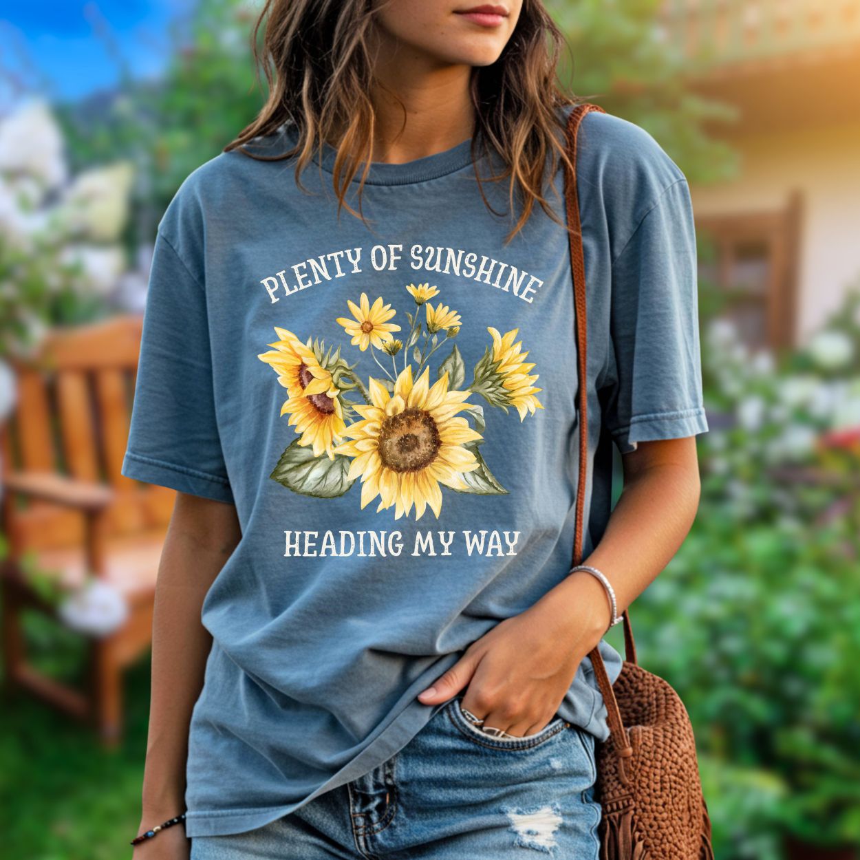 Garment-dyed blue t-shirt with "Plenty of sunshine heading my way" and a vibrant sunflower bouquet.