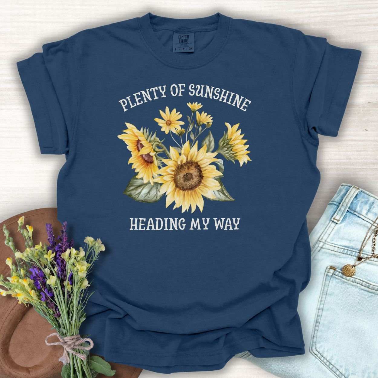 True Navy garment-dyed t-shirt with "Plenty of Sunshine Heading My Way" and sunflower graphic.