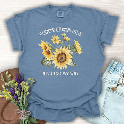Blue Jean garment-dyed cotton t-shirt with "Plenty of Sunshine Heading My Way" text and sunflower graphic.