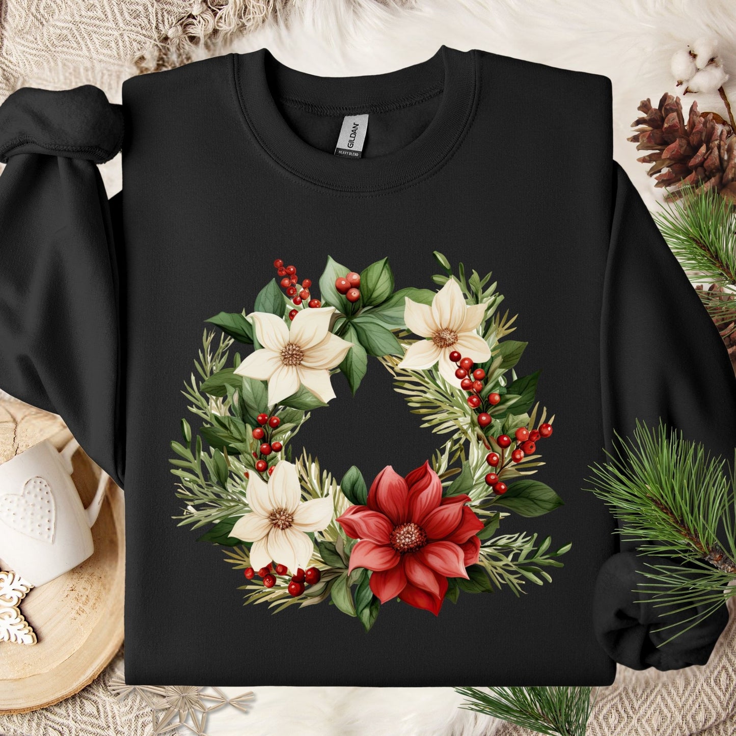 Black Gildan crewneck sweatshirt with a watercolor poinsettia wreath design in red, white, and green.