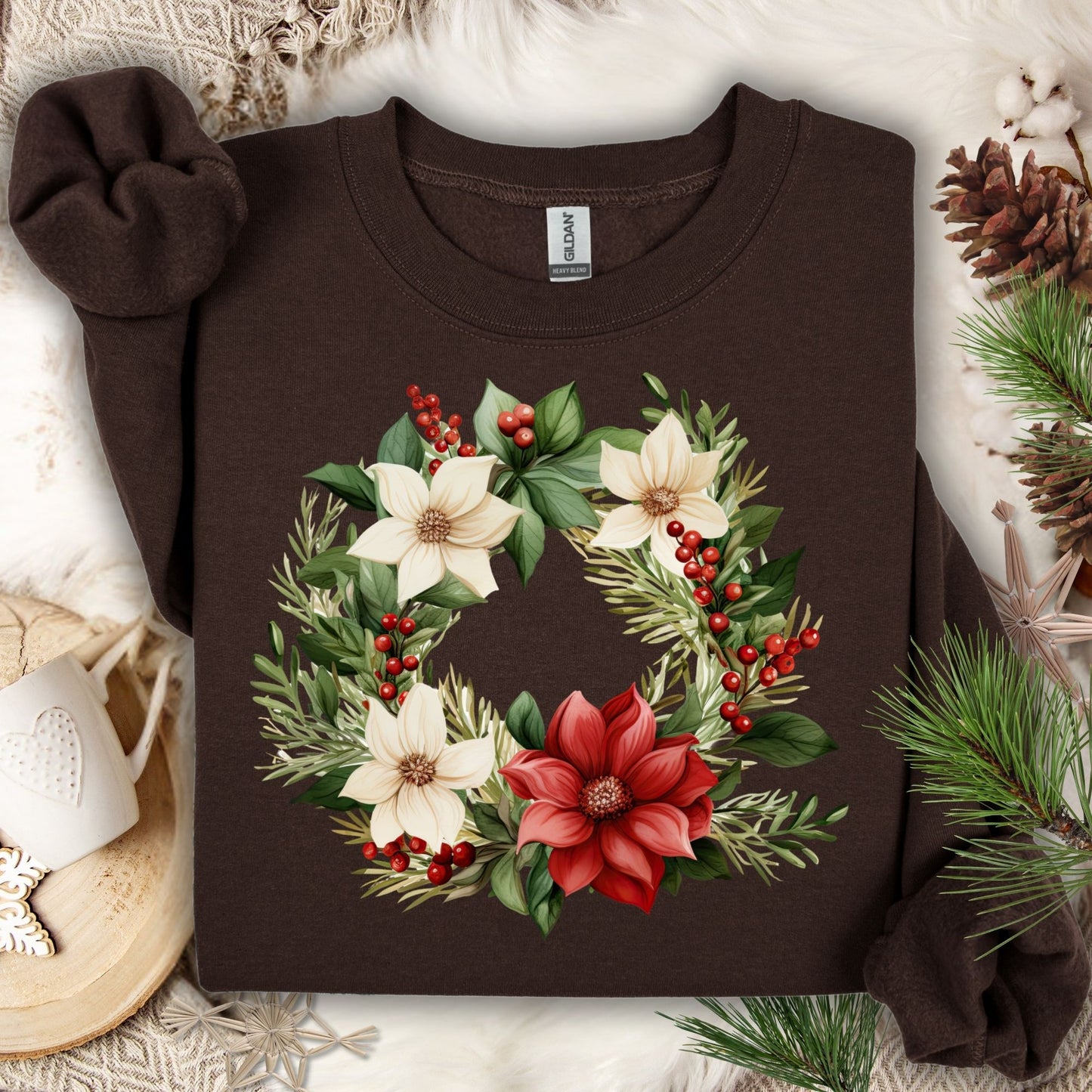 Dark Chocolate Gildan crewneck sweatshirt with a watercolor poinsettia wreath in red, white, and green.