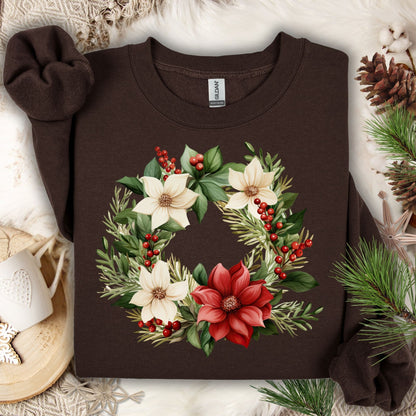 Dark Chocolate Gildan crewneck sweatshirt with a watercolor poinsettia wreath in red, white, and green.