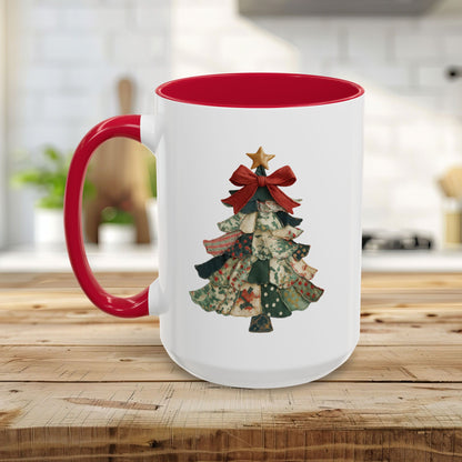 White ceramic mug with red interior and handle, featuring a patchwork Christmas tree design.