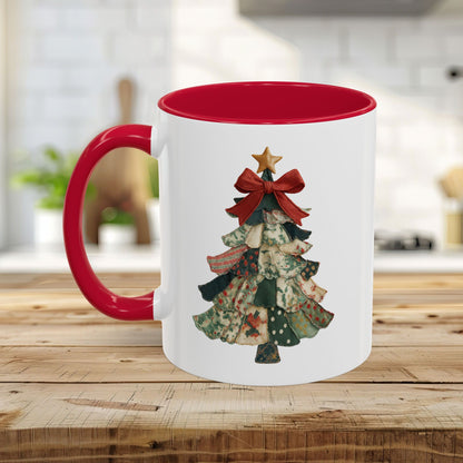 White ceramic mug with red interior and handle, featuring a patchwork Christmas tree design.