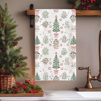 White microfiber tea towel with vintage-inspired Christmas trees, holly, and red bows.