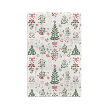 Microfiber tea towel with vintage-inspired Christmas trees, holly, and red bows on a light background.