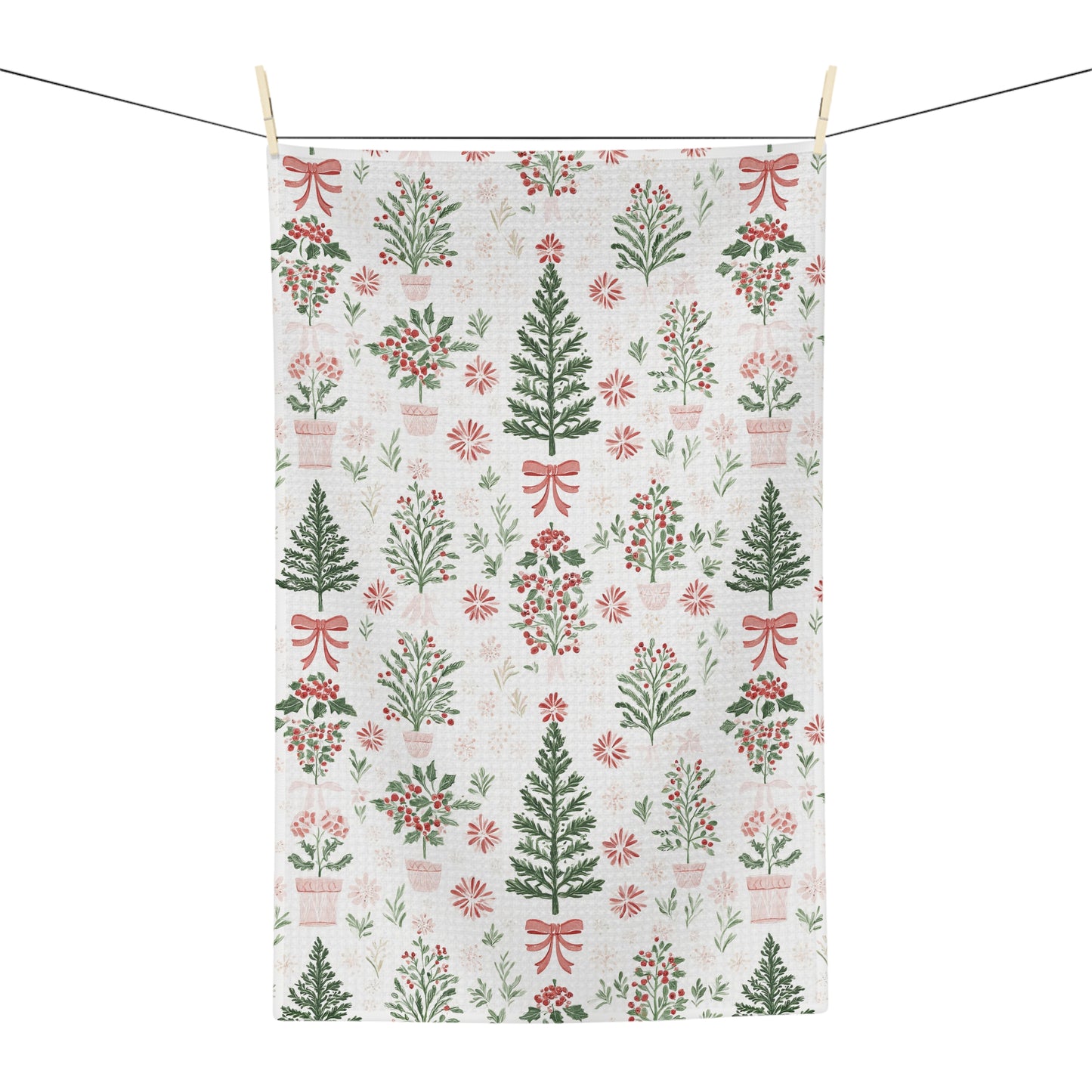 Microfiber tea towel with vintage-inspired Christmas trees, holly, and red bows on a light background.