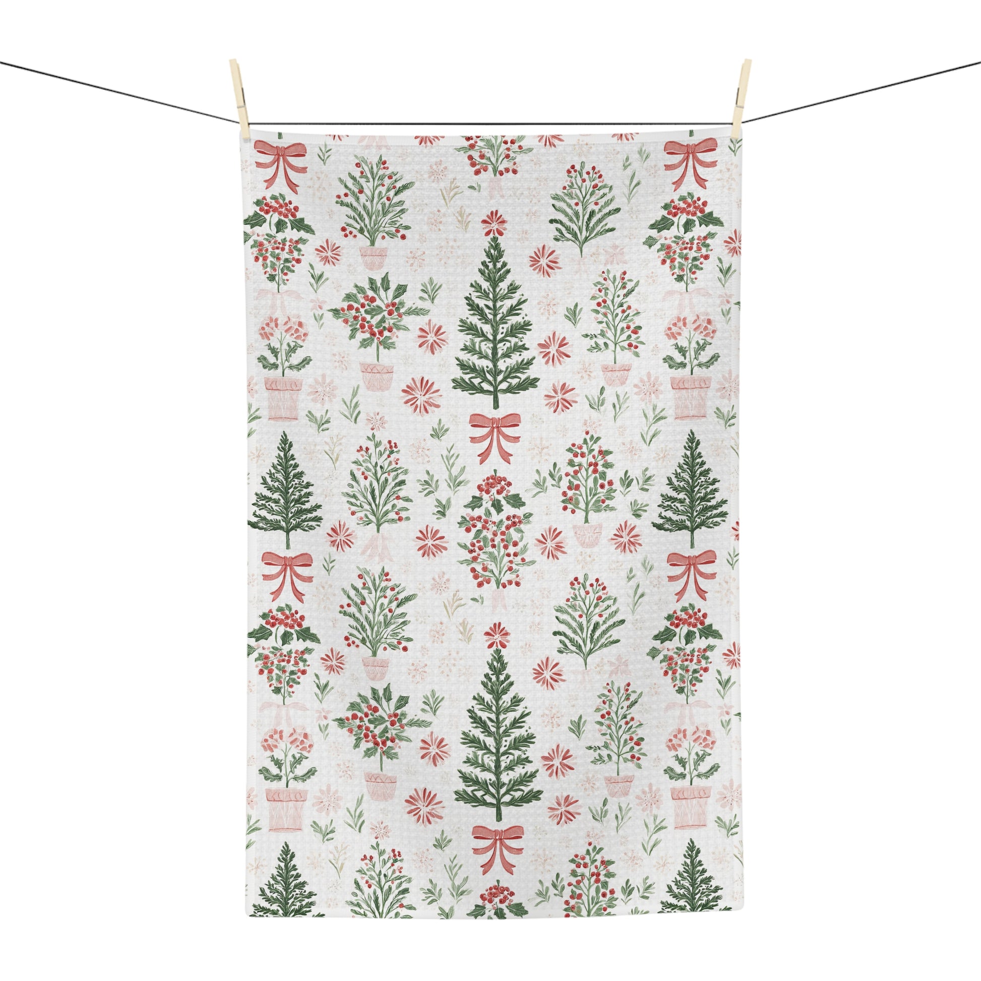 Microfiber tea towel with vintage-inspired Christmas trees, holly, and red bows on a light background.