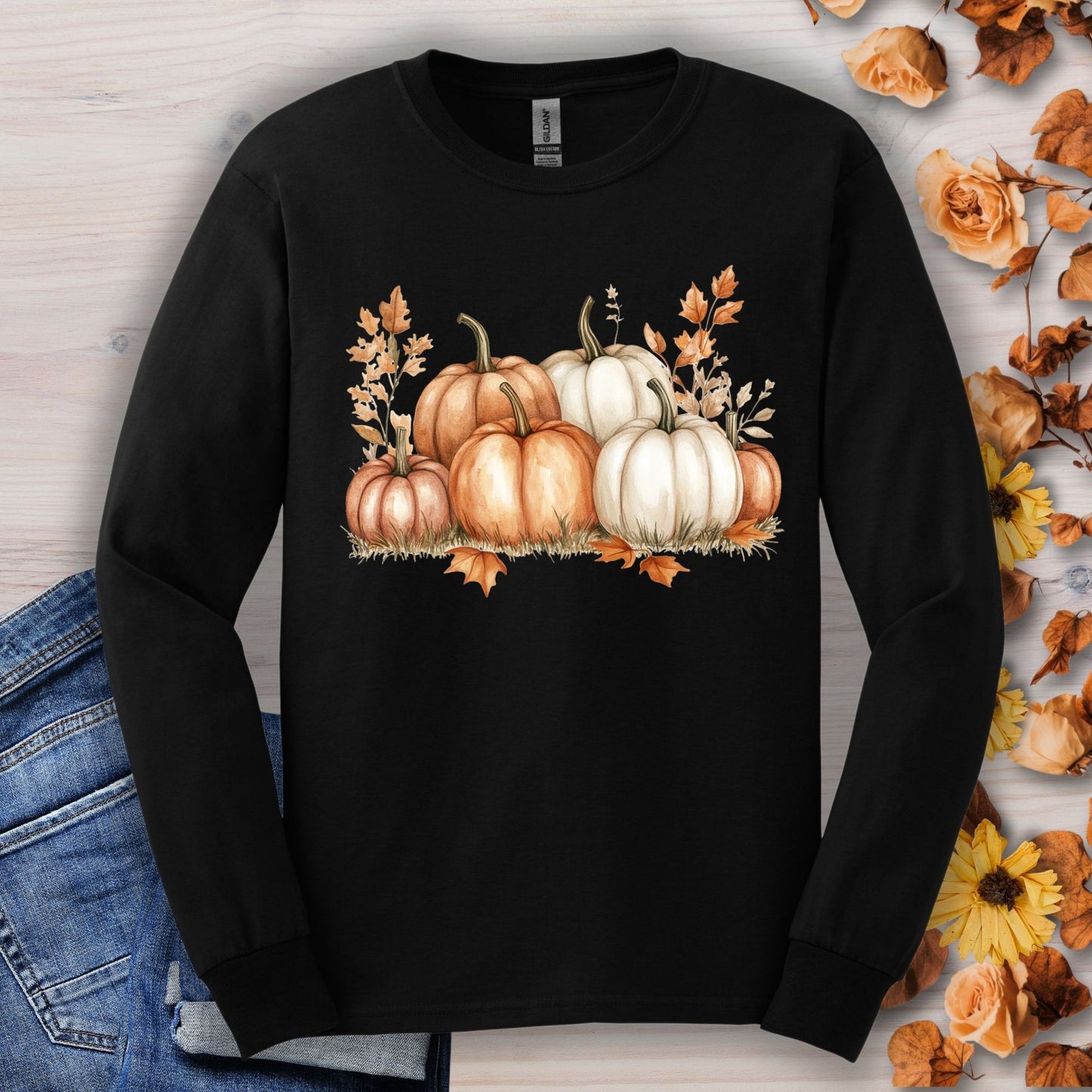 Black Gildan 2400 long sleeve tee with watercolor orange and white pumpkins, surrounded by fall leaves.