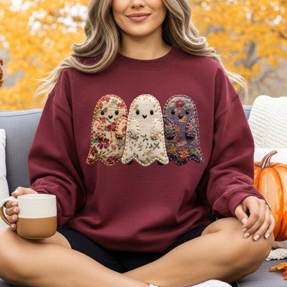 Maroon Quilted Ghosts Sweatshirt with three floral fabric ghosts, worn by a woman outdoors.