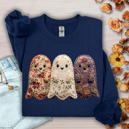 Navy Gildan sweatshirt with three embroidered floral fabric ghosts, styled with jeans and autumn leaves.