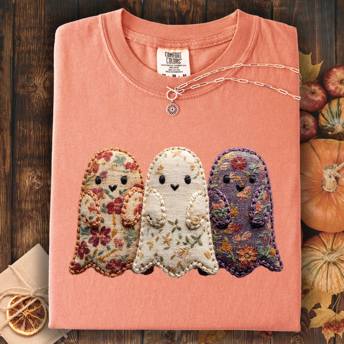 Terracotta Comfort Colors t-shirt with three embroidered floral fabric ghosts and a silver necklace.