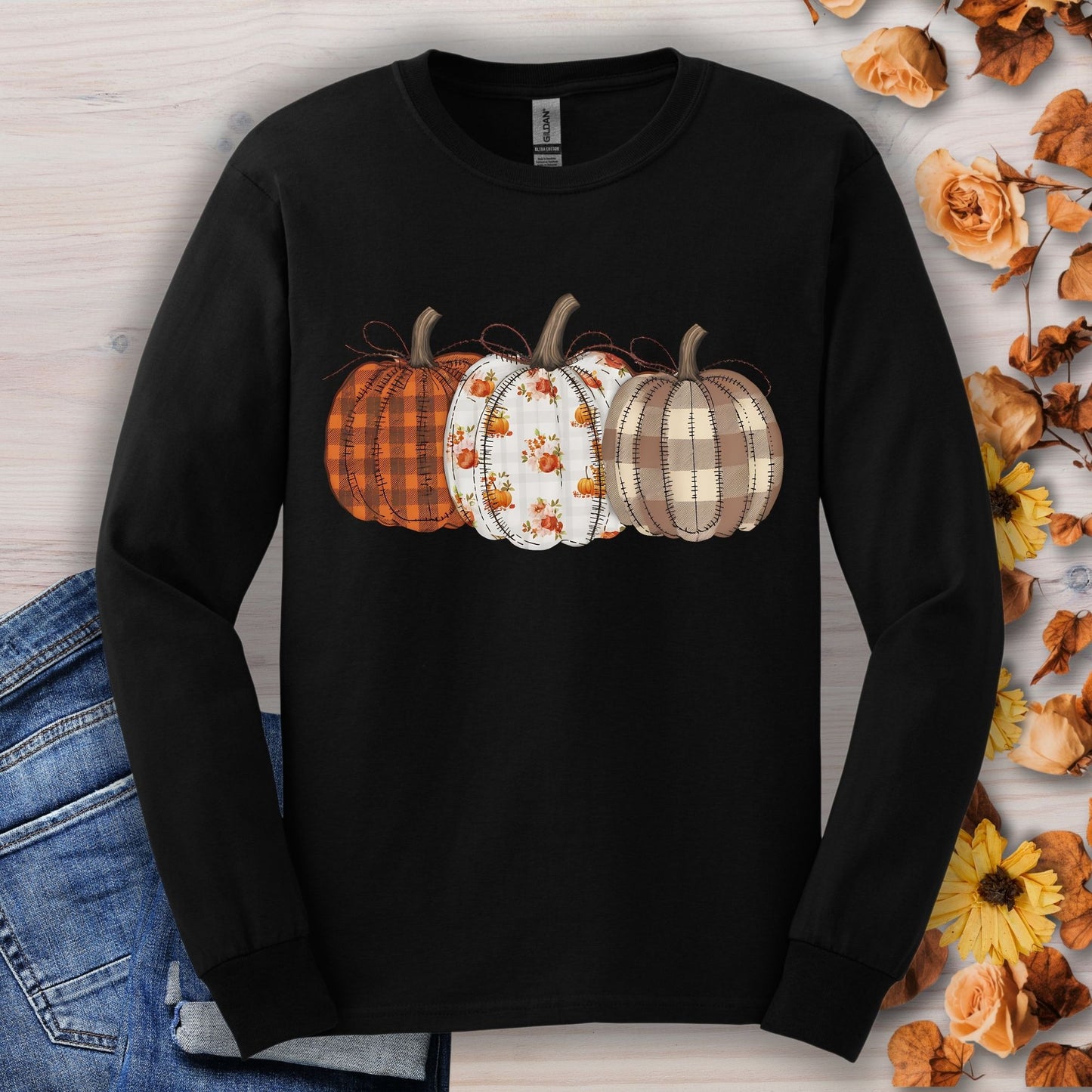 Black long sleeve tee with 3 quilted pumpkins: plaid, floral, and checkered designs.