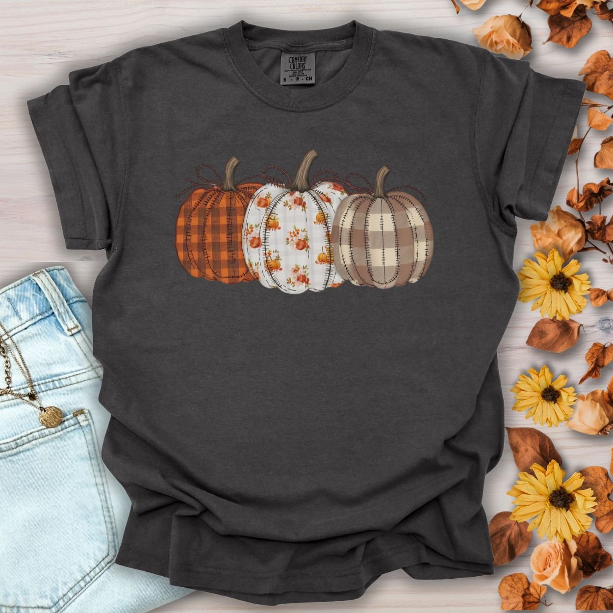 Pepper Quilted Pumpkins T-Shirt with three patterned pumpkins in plaid, gingham, and leaf motifs.