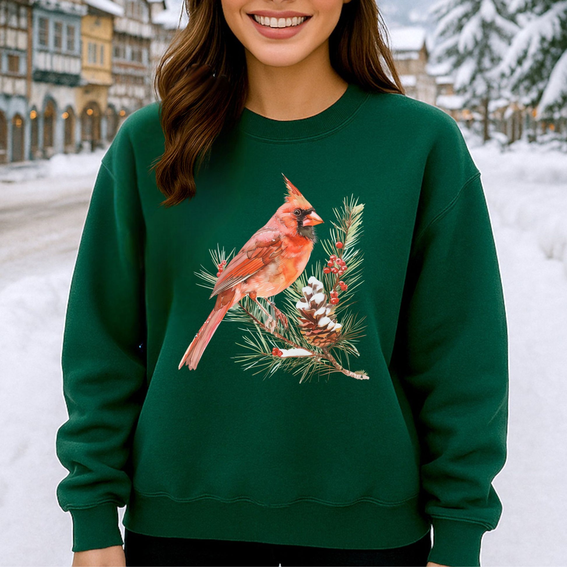 Green sweatshirt with a red cardinal on a snowy evergreen branch illustration, featuring a prominent crest and detailed feathers.