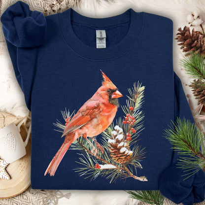 Navy sweatshirt with a red cardinal on a snowy evergreen branch illustration.