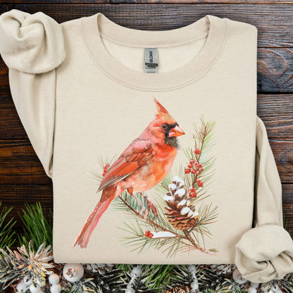 Sand sweatshirt with a red cardinal on a snowy evergreen branch design.