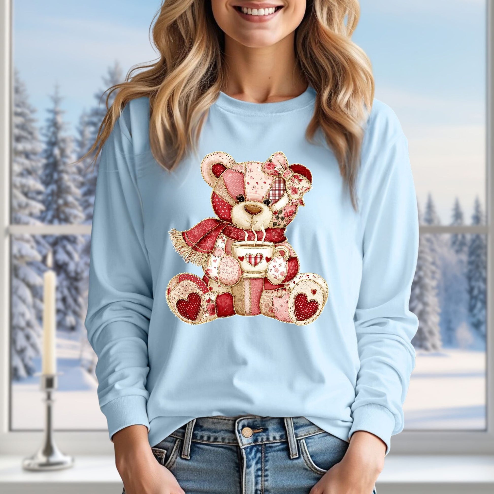 Light blue long-sleeve tee with a red patchwork country teddy bear holding a hot chocolate mug.