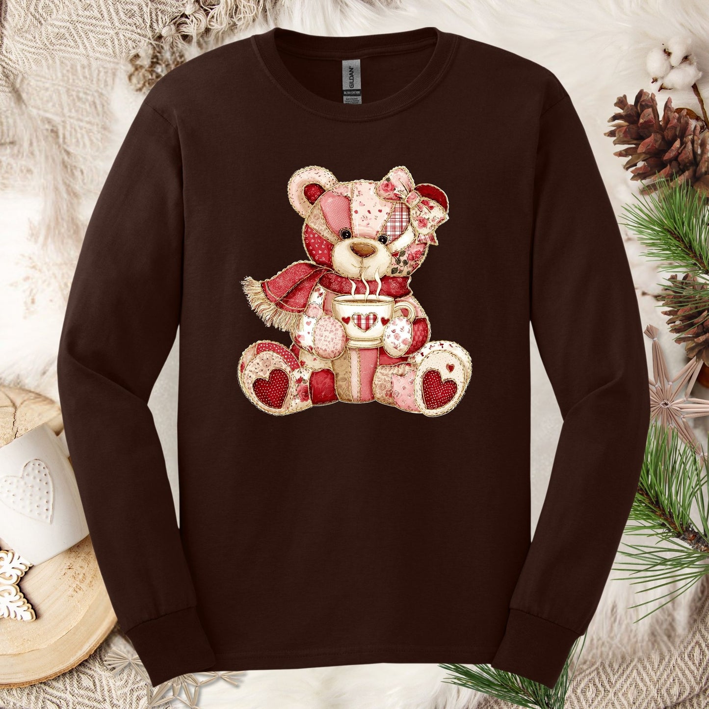 Dark chocolate long-sleeve tee with a patchwork country teddy bear holding hot chocolate.