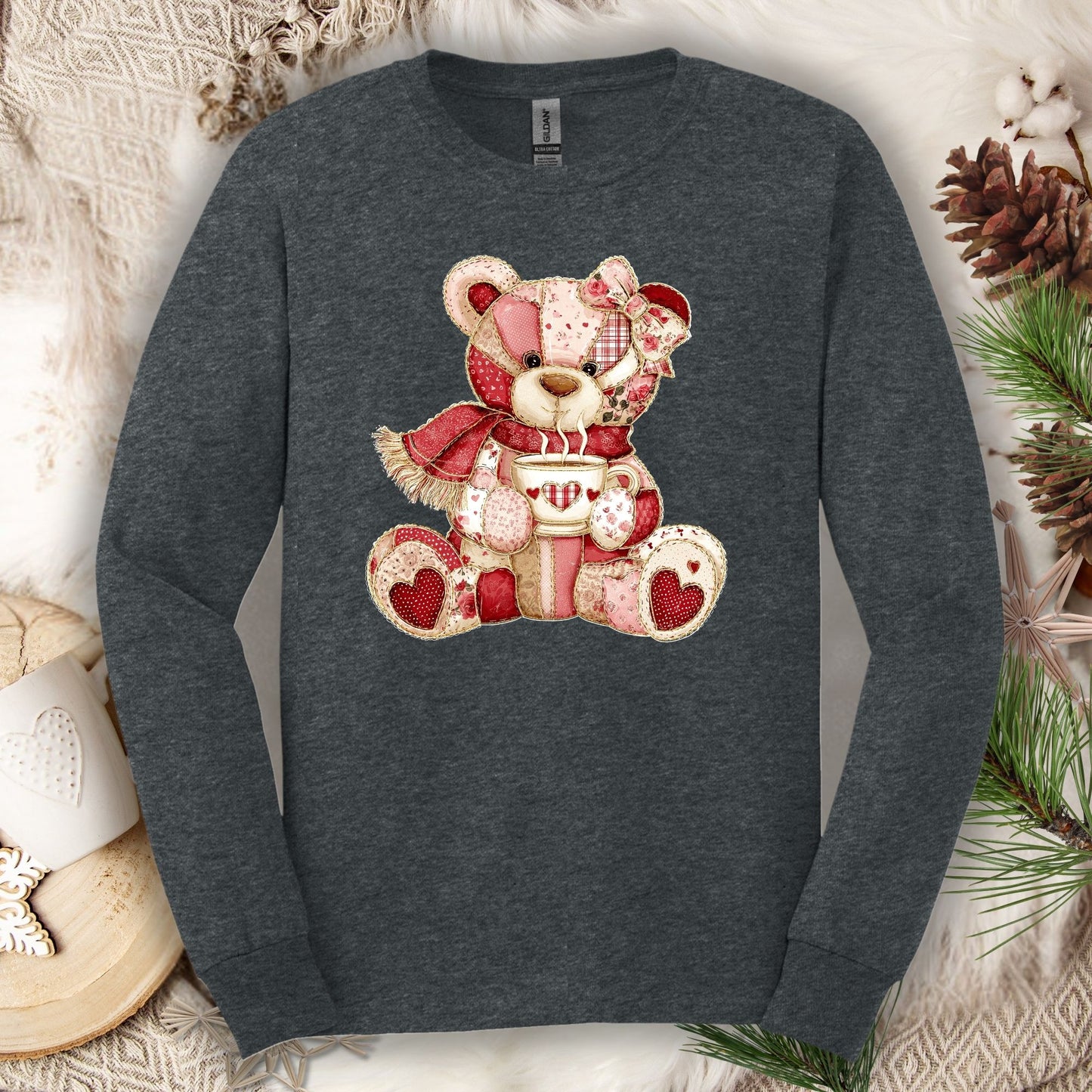 Dark heather long-sleeve tee with a red patchwork country teddy bear holding hot chocolate.