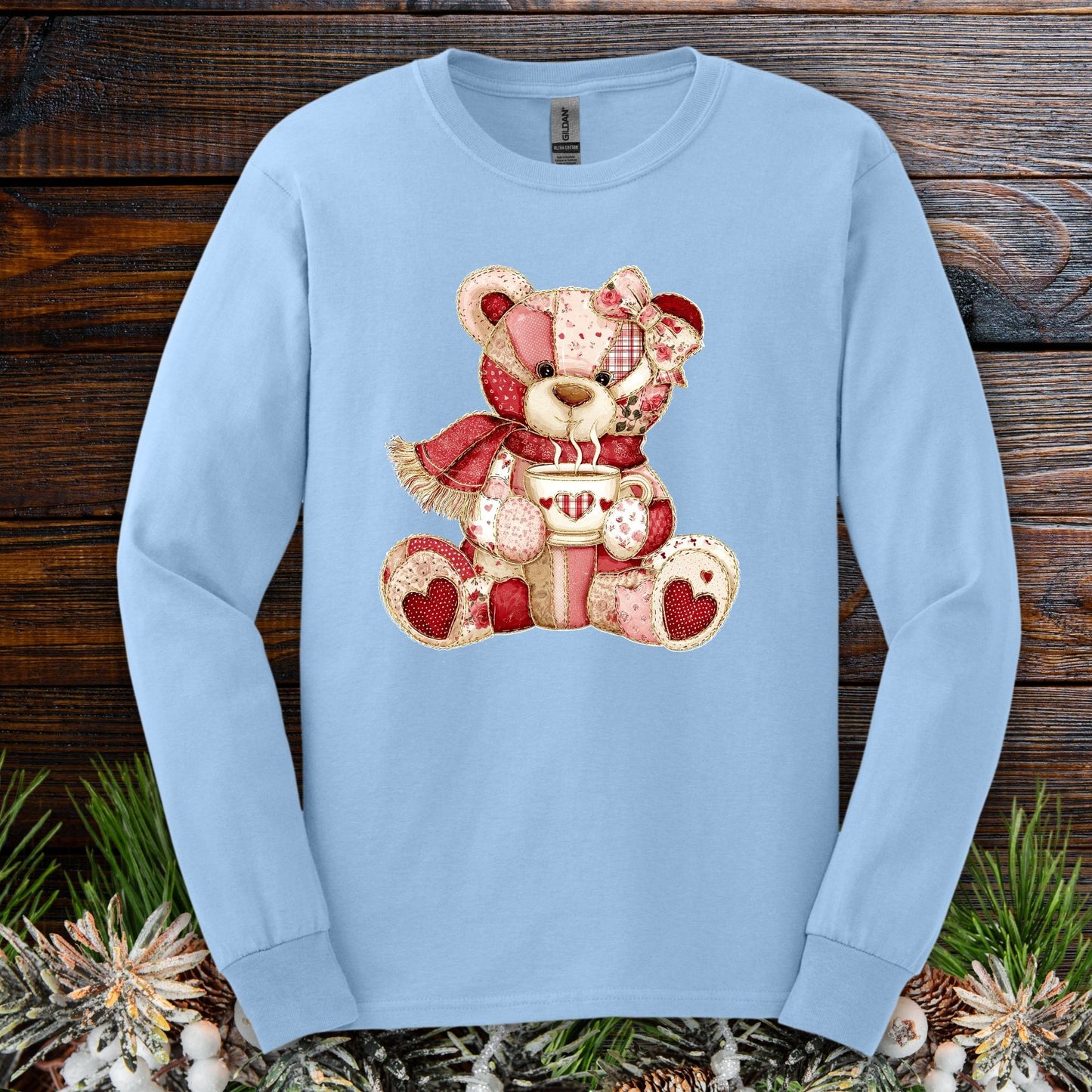Light blue long-sleeve tee with a patchwork teddy bear holding hot chocolate, S size.