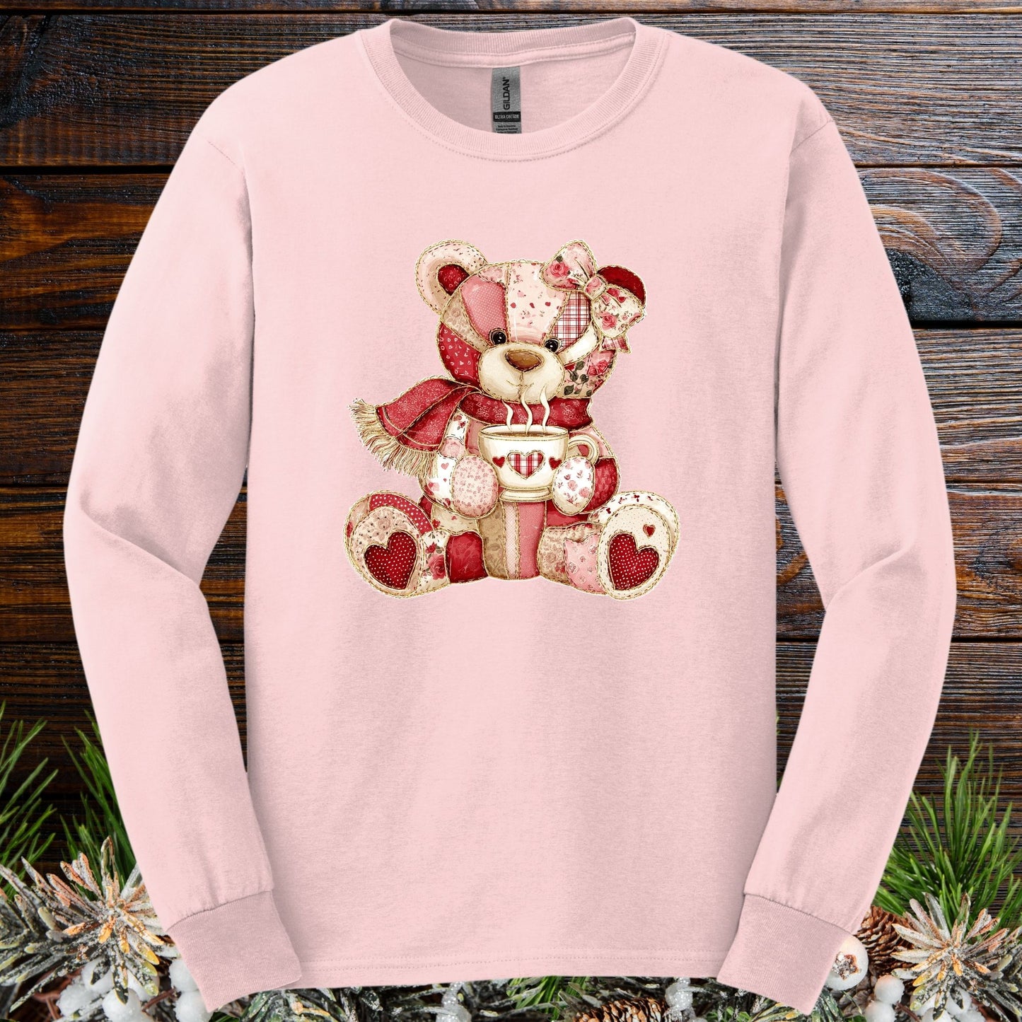 Light pink long-sleeve tee with a patchwork country teddy bear holding a hot chocolate mug.