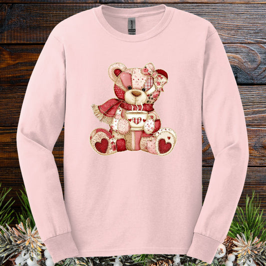 Light pink long-sleeve tee with a patchwork country teddy bear holding a hot chocolate mug.