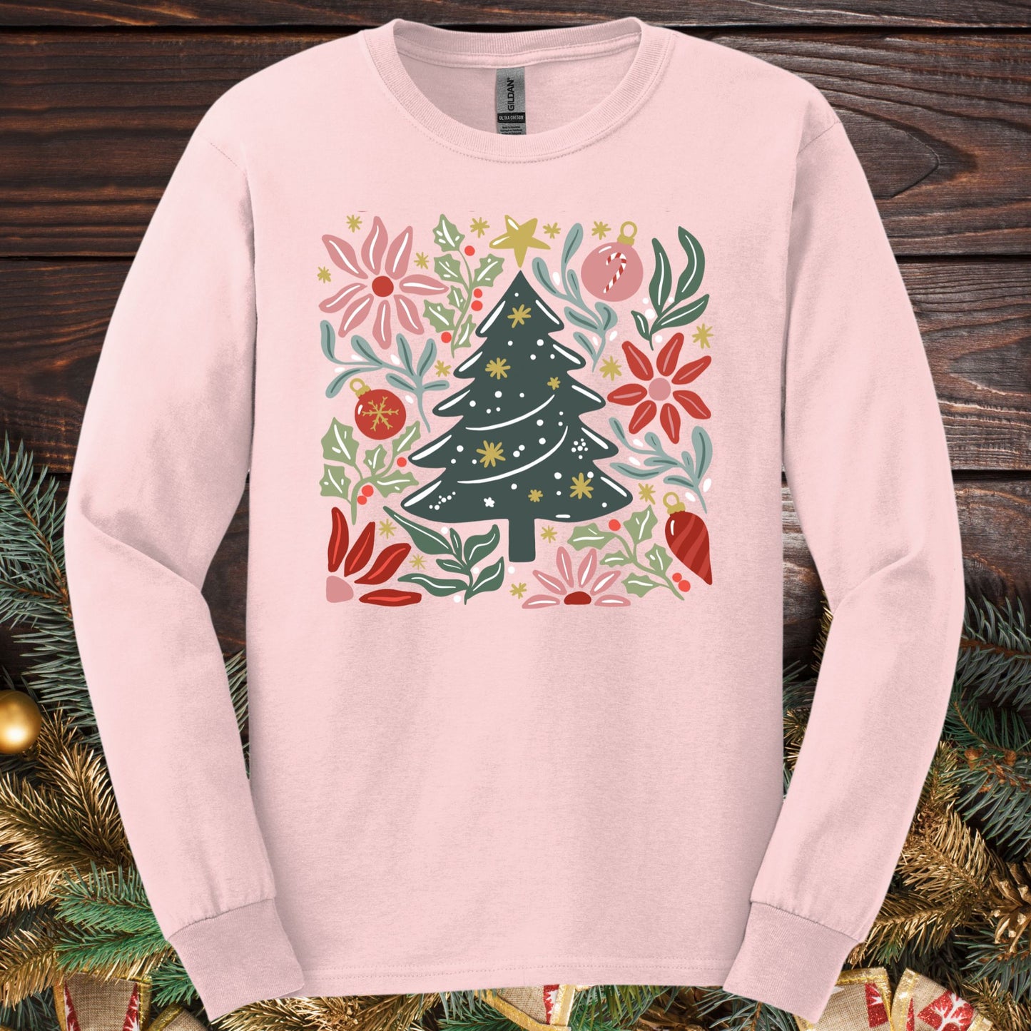 Light pink Gildan Softstyle long sleeve tee with a retro watercolor Christmas tree and floral design.