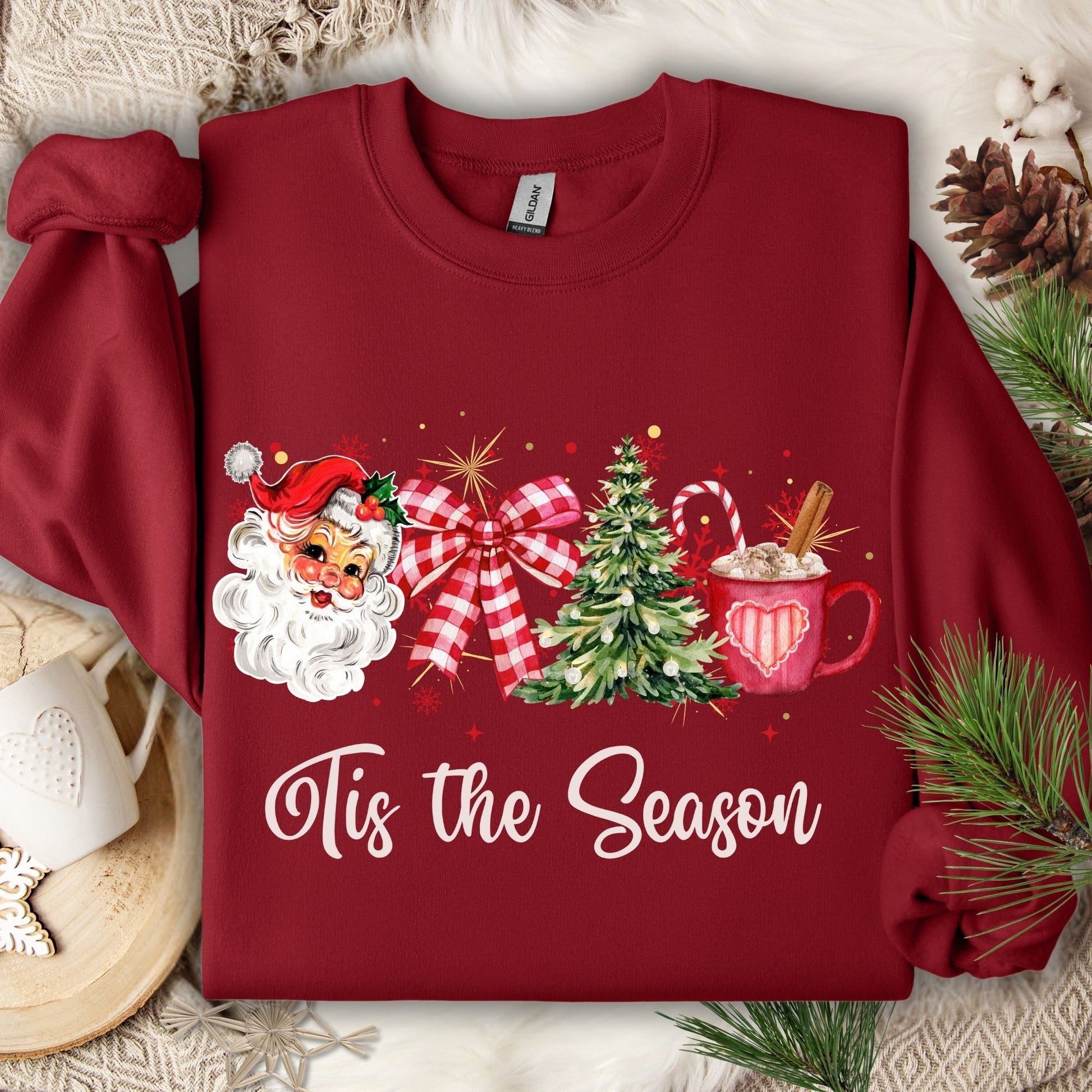 Red Gildan long sleeve tee with retro Santa, Christmas tree, red bow, hot cocoa, and "Tis the Season" text.