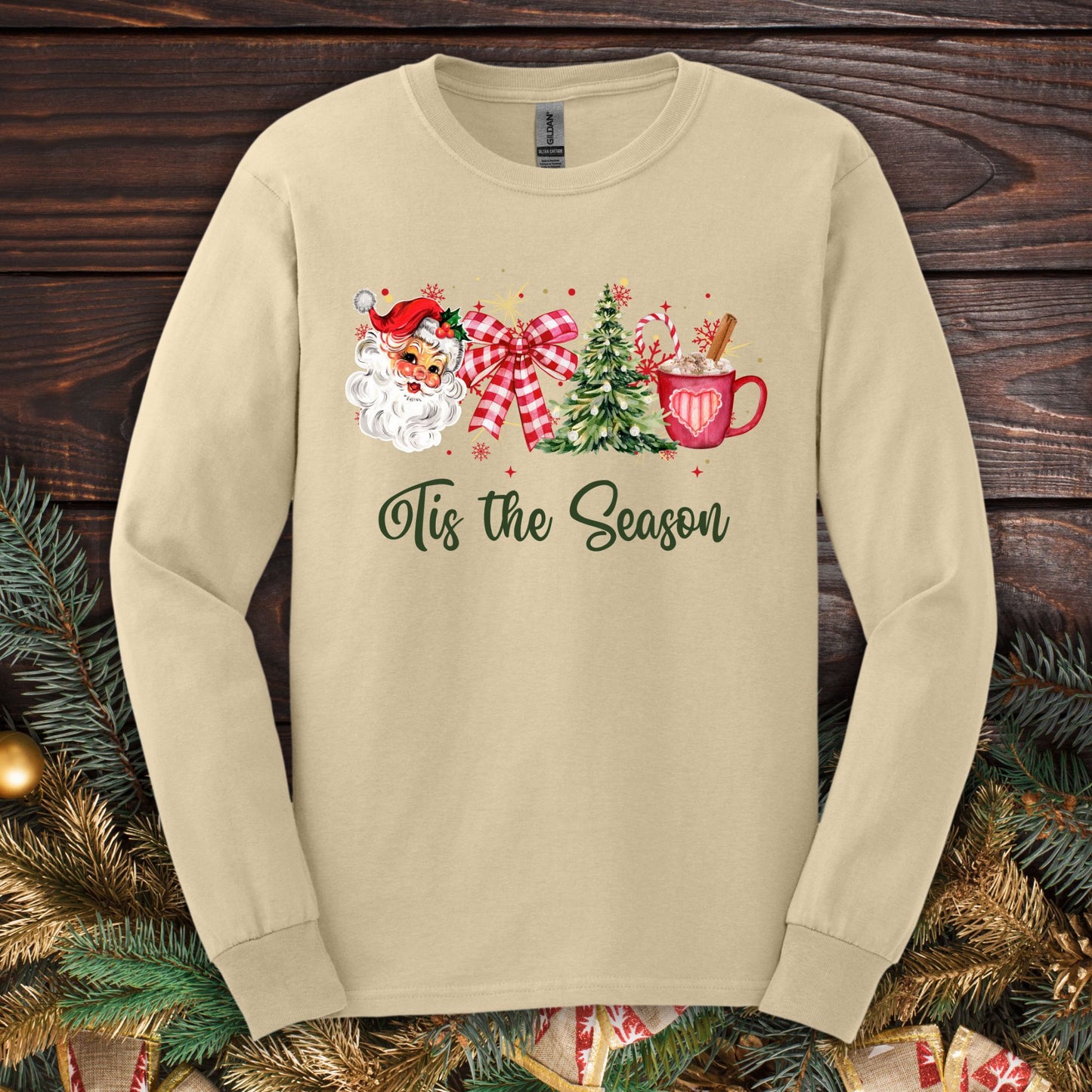 Retro Tis the Season long sleeve tee with 1950s Santa, tree, ribbon, and hot cocoa design.