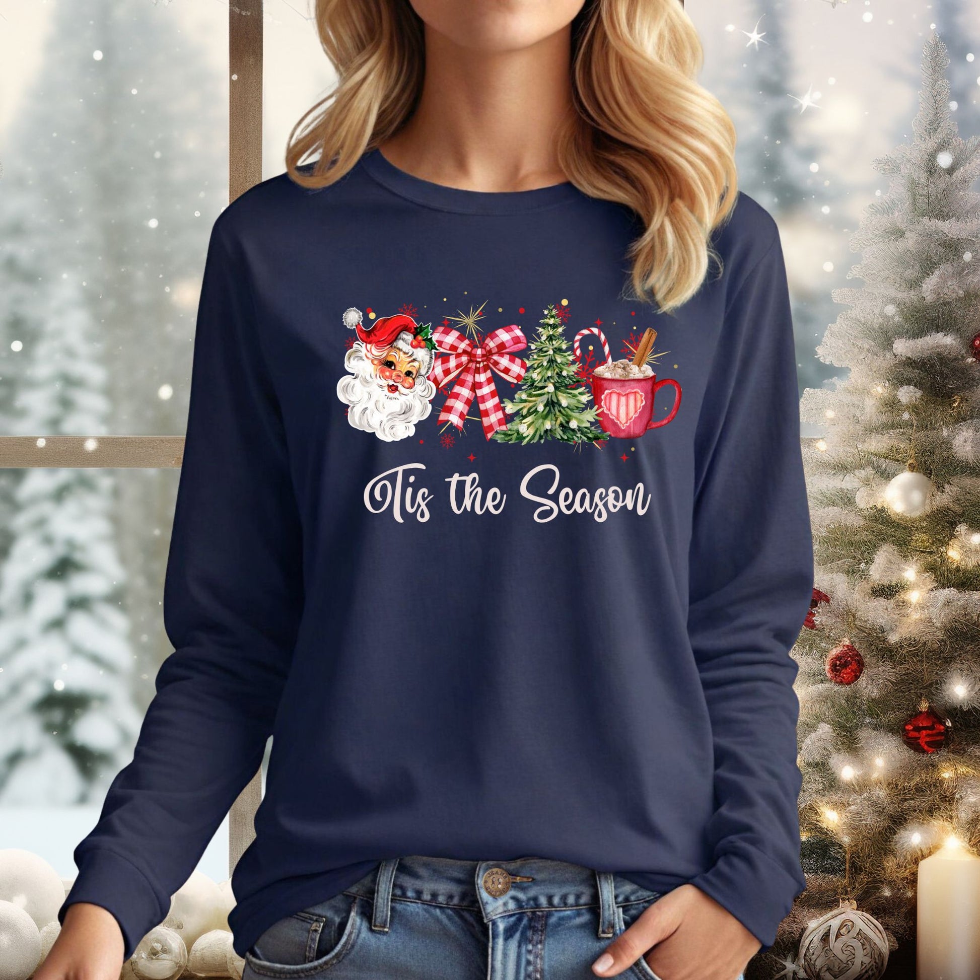 Navy long sleeve tee with retro Santa, Christmas tree, red ribbon, hot cocoa, and "'Tis the Season" text.
