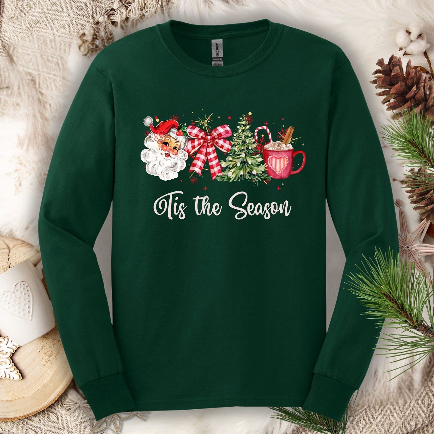 Forest Green long sleeve tee with retro Santa, tree, ribbon, cocoa, and "'Tis the Season" text.