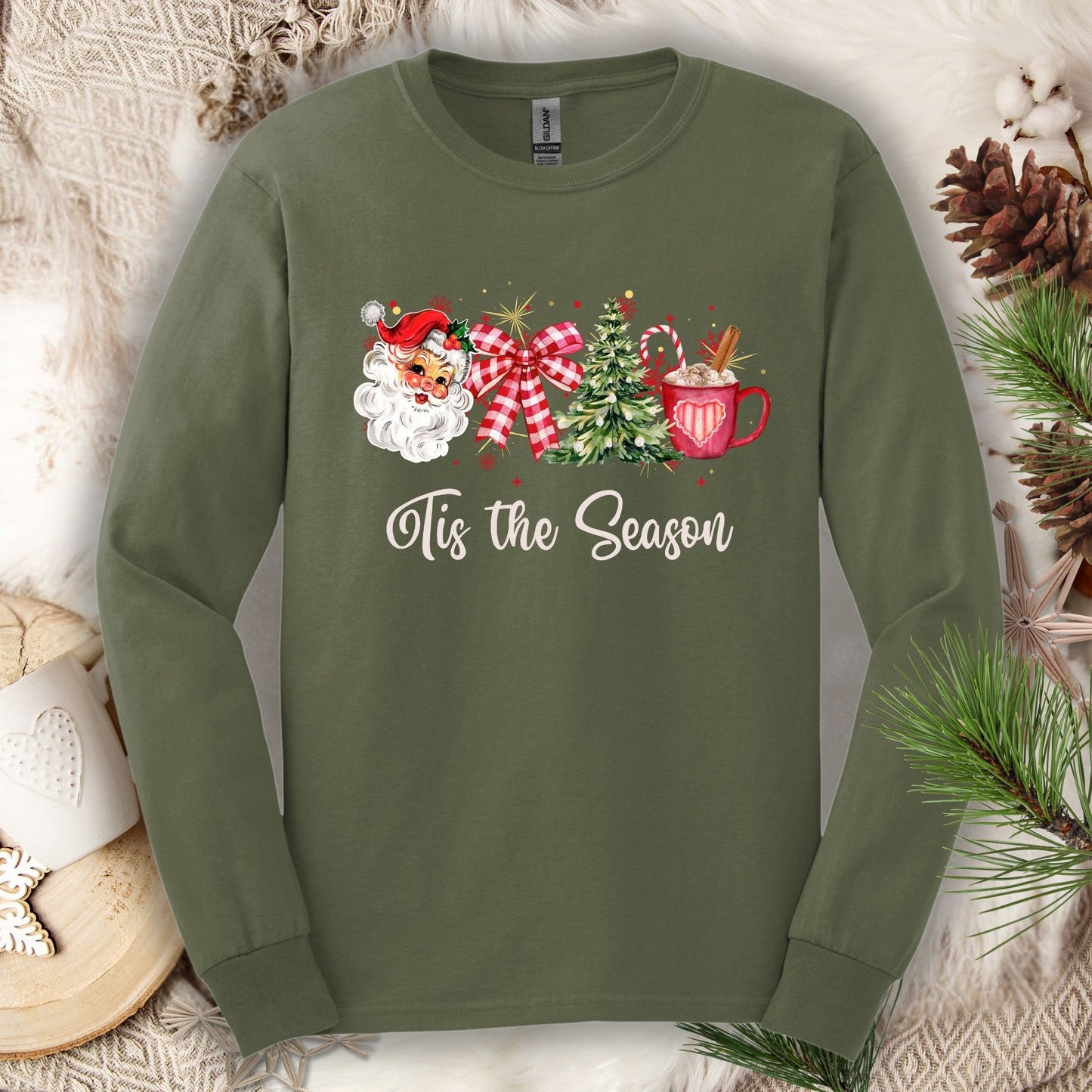 Military Green long sleeve tee with retro Santa, tree, red ribbon, cocoa, and "'Tis the Season" text.