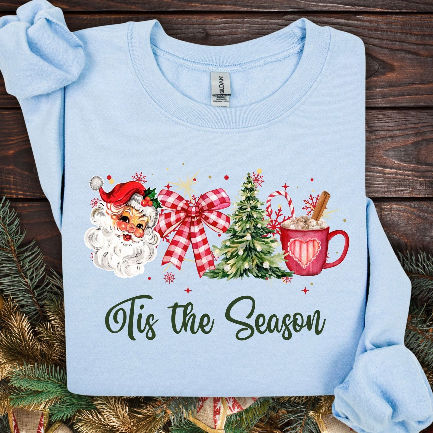 Light blue Gildan sweatshirt with retro Santa, plaid bow, Christmas tree, and cocoa mug design.