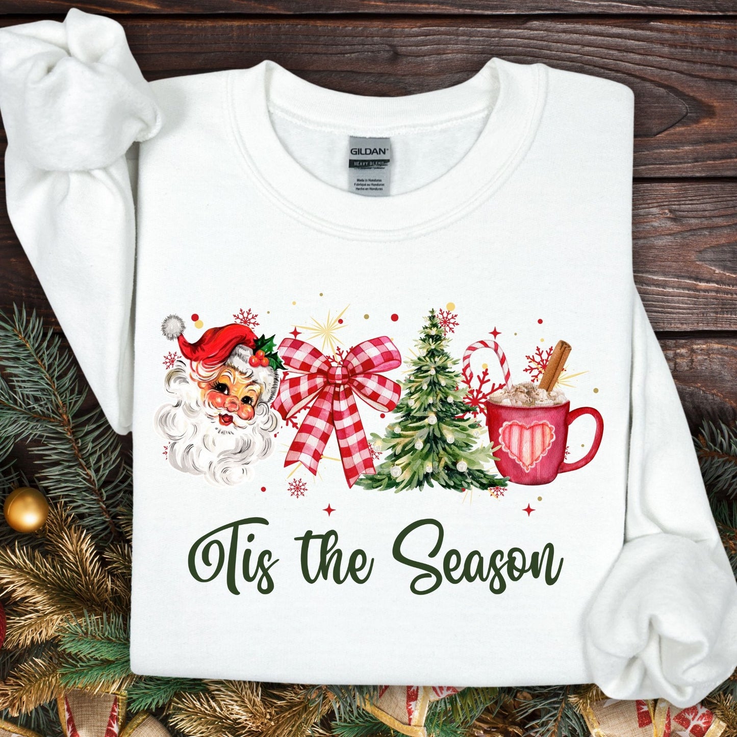 White Gildan sweatshirt with retro 1950s Santa, red bow, Christmas tree, and hot cocoa design.