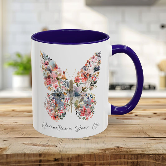11oz white ceramic mug with blue interior/handle, featuring a watercolor floral butterfly and "Romanticize Your Life" text.