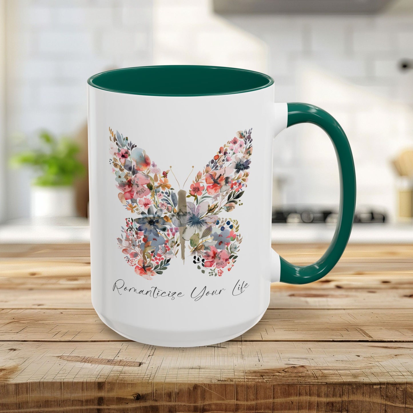 White 15oz ceramic mug with a green handle and interior, featuring a watercolor floral butterfly and "Romanticize Your Life" text.
