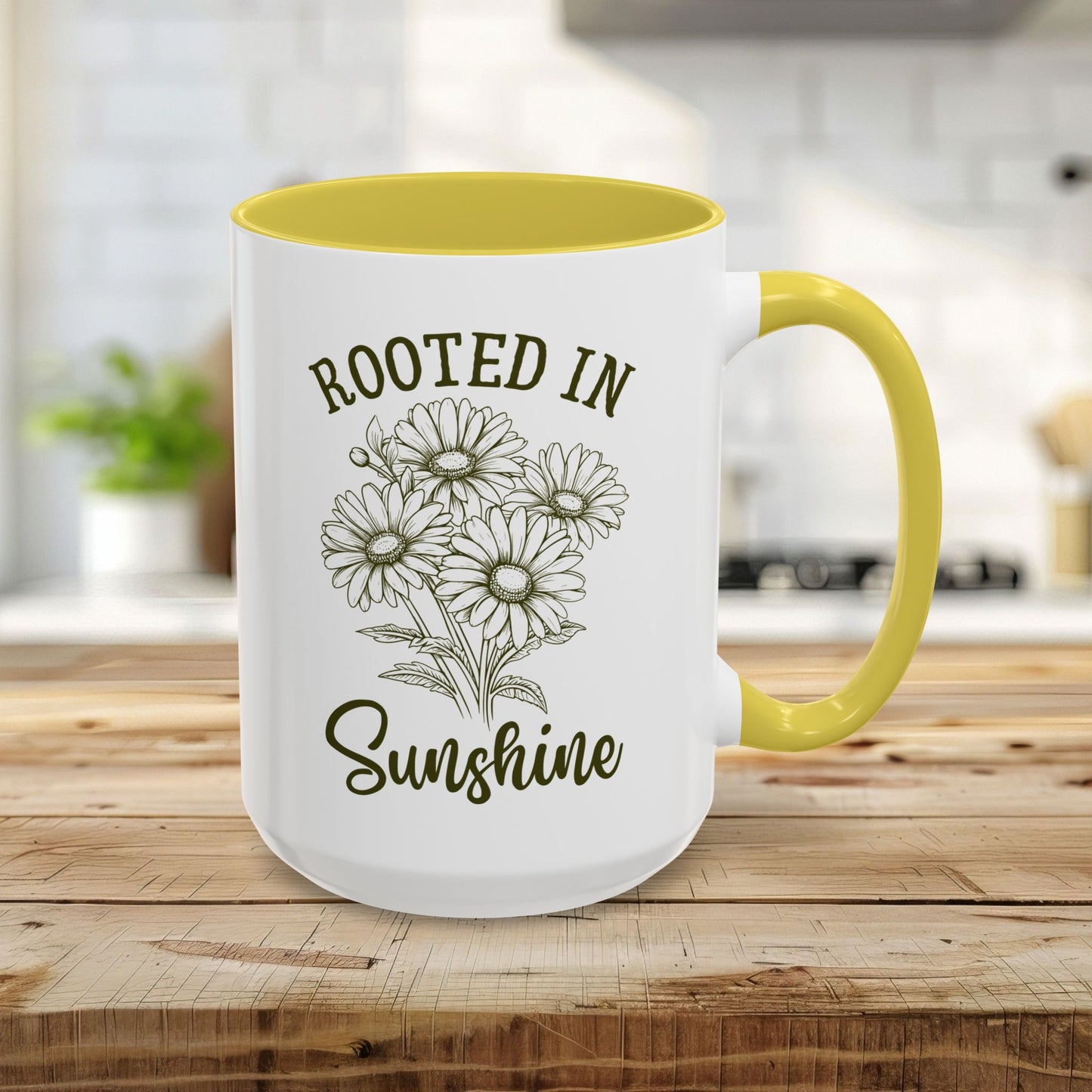 15oz white ceramic mug with yellow interior and handle, featuring hand-drawn daisies and "Rooted in Sunshine" text.