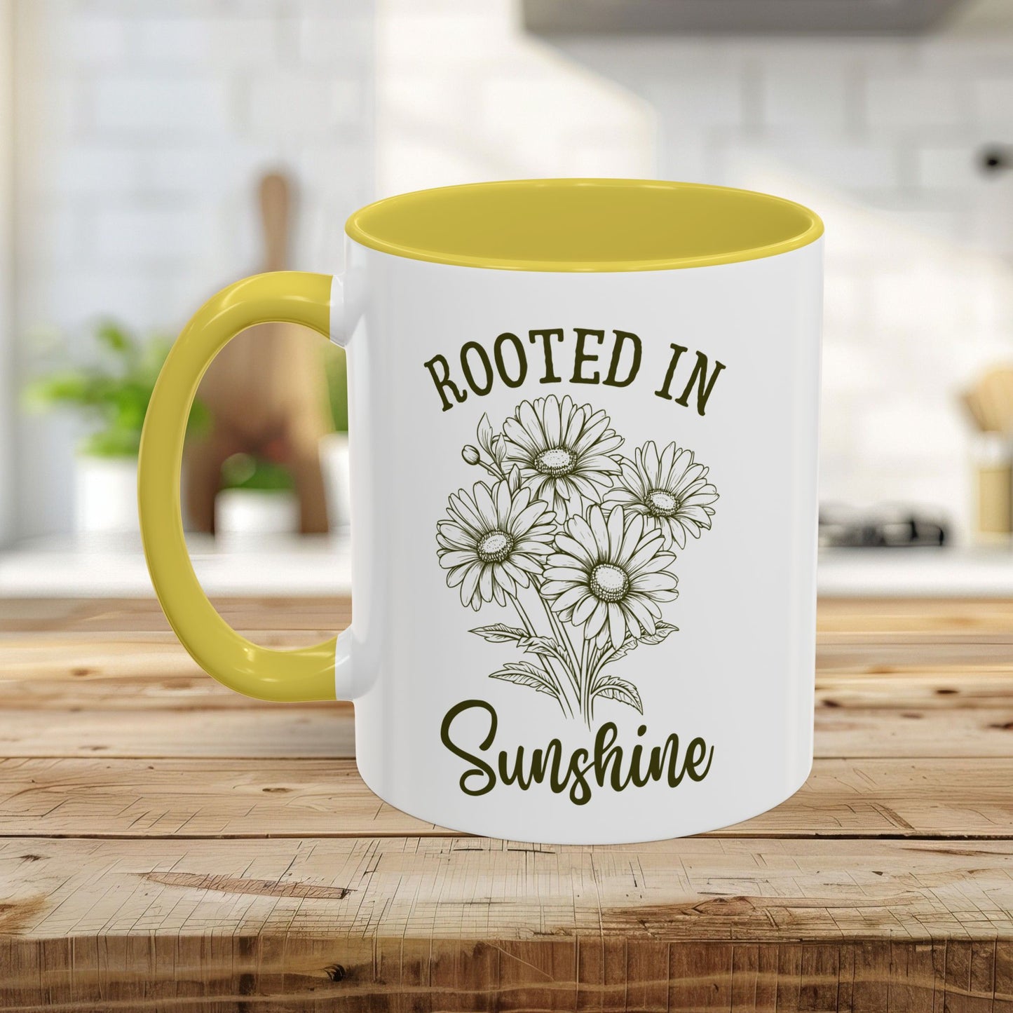 White ceramic mug with yellow interior and handle, featuring a "Rooted in Sunshine" daisy design.