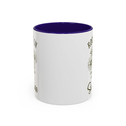 White ceramic mug with purple interior and handle, featuring a hand-drawn daisy and text.