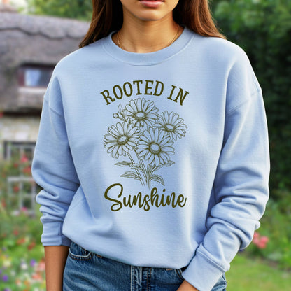 Light blue unisex sweatshirt with "Rooted in Sunshine" text and hand-drawn daisy bouquet.