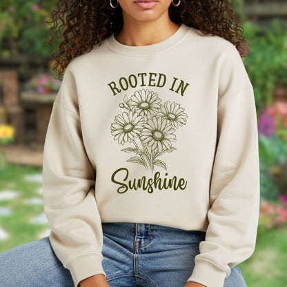 Beige unisex sweatshirt with "Rooted in Sunshine" text and a hand-drawn daisy bouquet design.