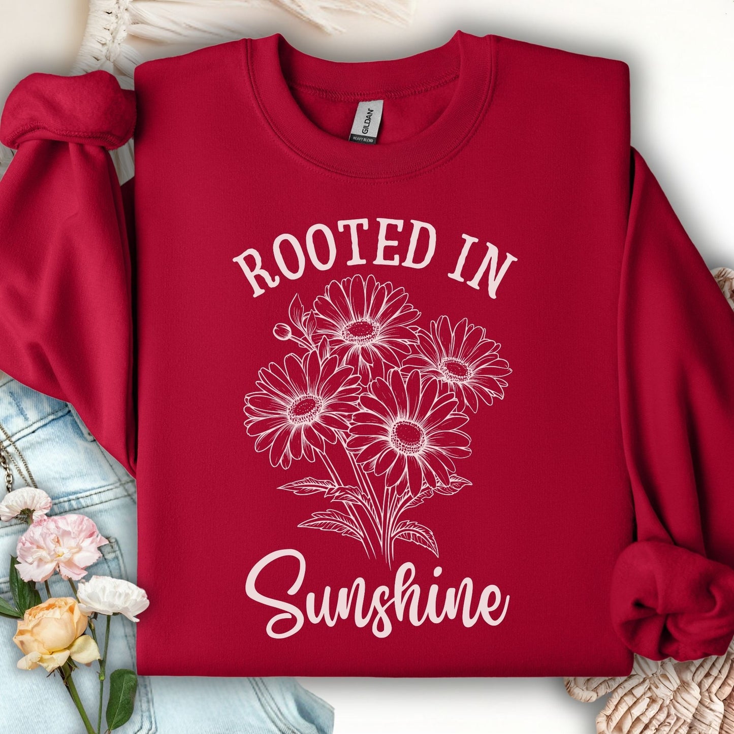 Cardinal Red Daisy Sweatshirt with "Rooted in Sunshine" text and hand-drawn daisy bouquet design.