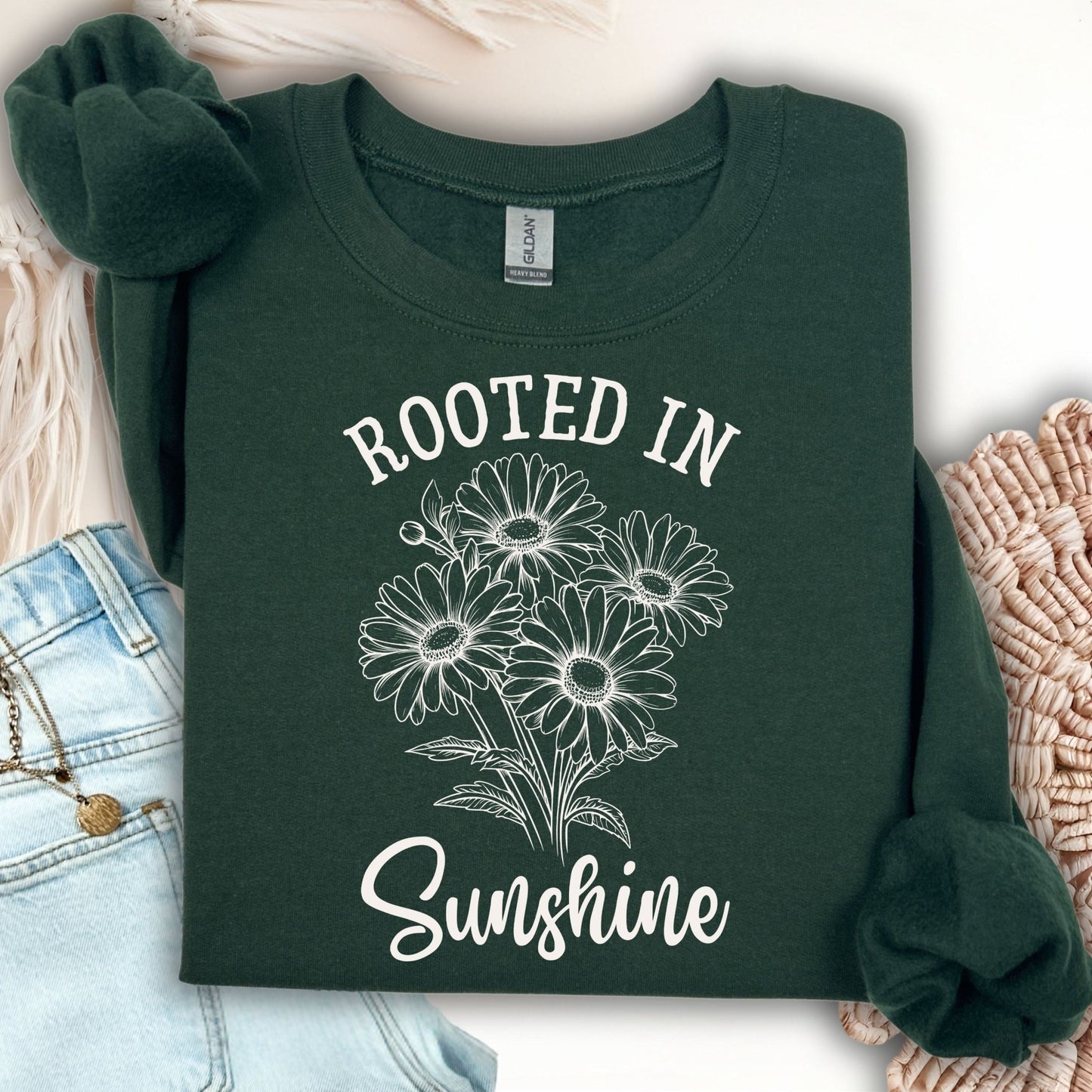 Forest Green unisex sweatshirt with "Rooted in Sunshine" and a hand-drawn daisy bouquet design.