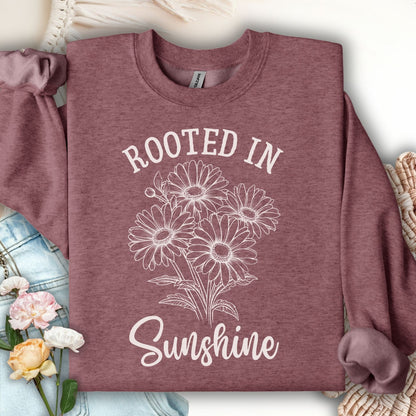 Heather Sport Dark Maroon daisy sweatshirt with "Rooted in Sunshine" graphic, cotton-polyester blend.