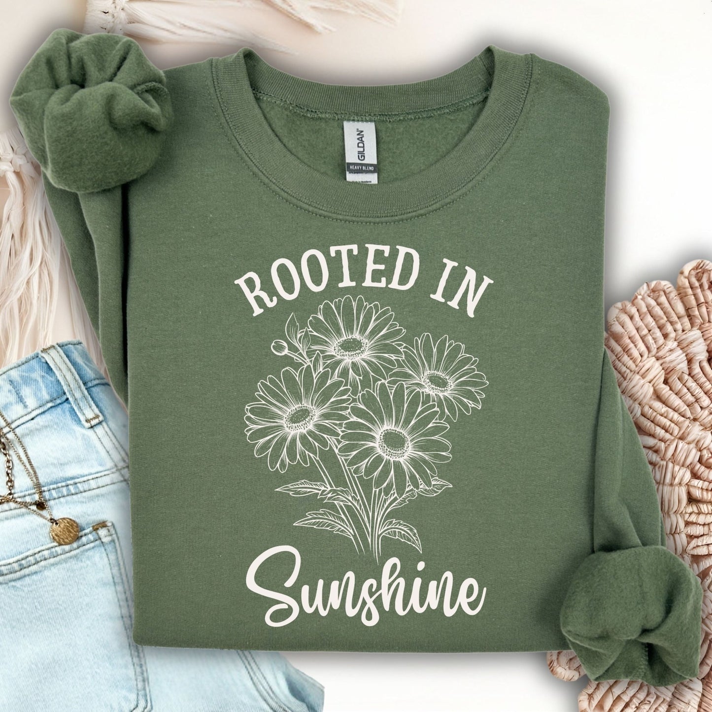 Military Green Daisy Sweatshirt with "Rooted in Sunshine" text and floral graphic.